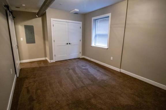a empty room with a door and a window