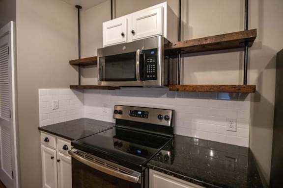 a kitchen with a stove and a microwave