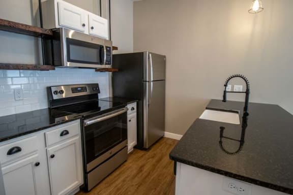 a kitchen with a stove and a refrigerator