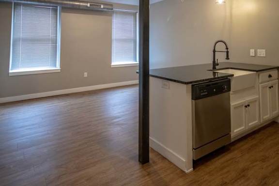 an empty kitchen with a stove and a sink