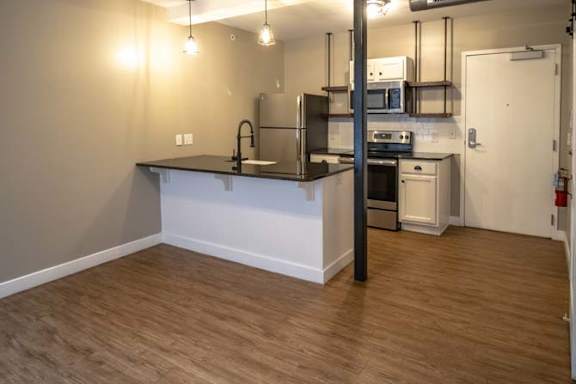 an empty kitchen with a counter in the middle