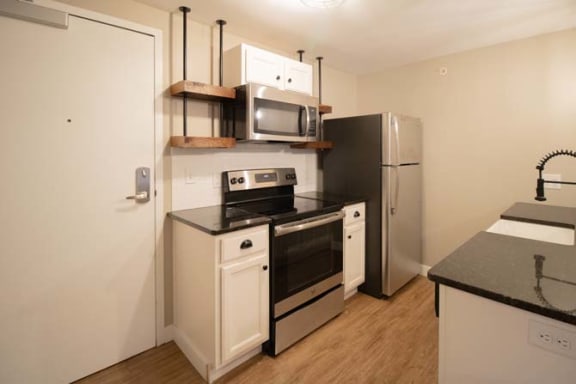 a kitchen with a stove and a refrigerator