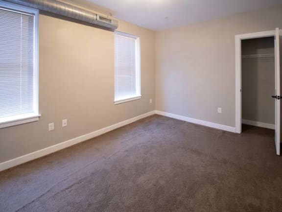 an empty room with a door and a window