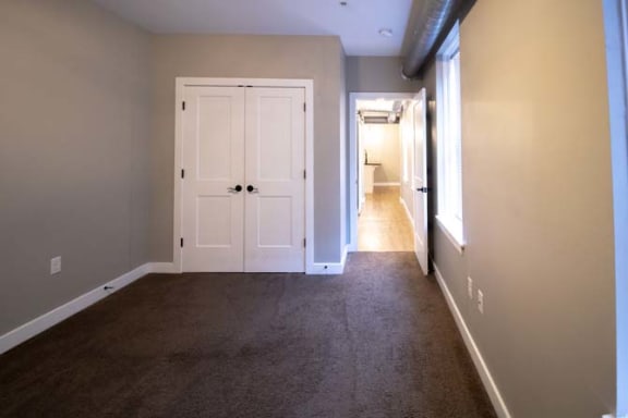 a empty room with a door and a carpet