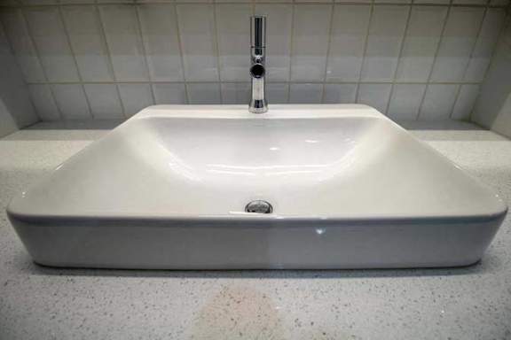 a white sink with a faucet in a bathroom