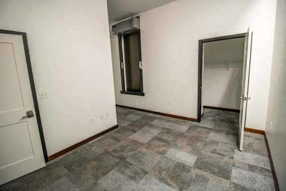 an empty room with a door and a mirror