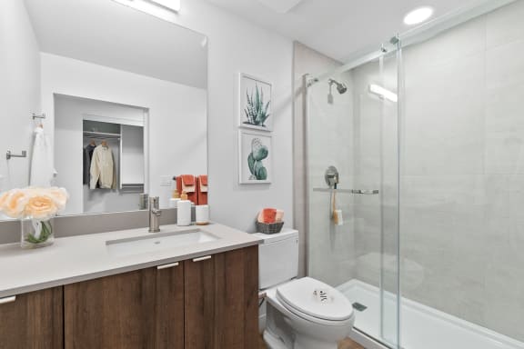 a bathroom with a toilet sink and shower in a 555 waverly unit