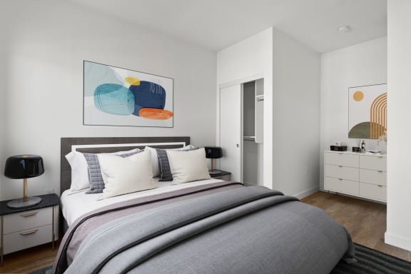 a bedroom with a bed and a dresser in a 555 waverly unit