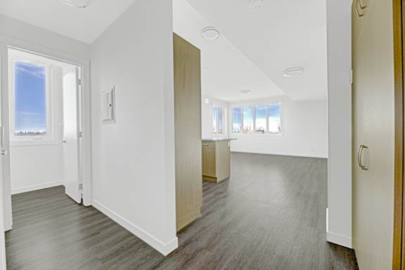 A room with white walls and a window overlooking the beach.