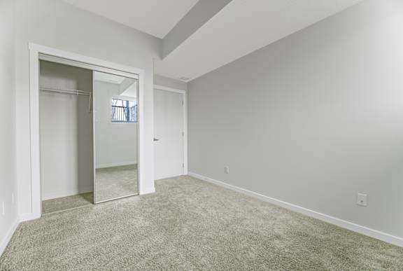 A room with a carpeted floor and white walls.