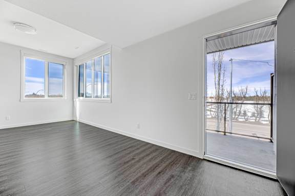 A room with a large window and a view of a snowy landscape outside.