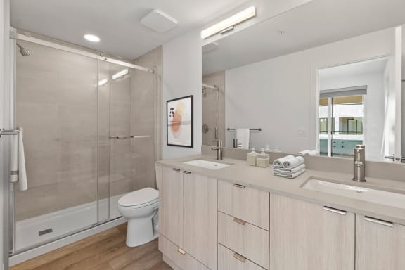 a bathroom with a toilet sink and shower