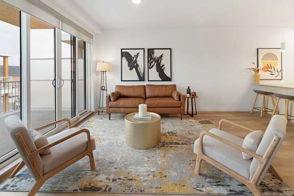a living room with couches and chairs and a rug