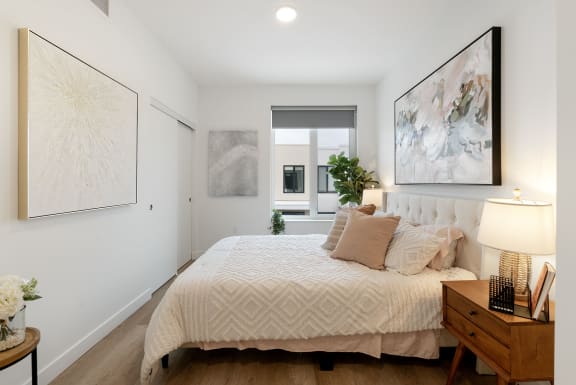 a bedroom with a large bed and a window