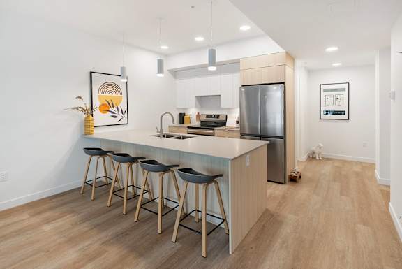 a kitchen with a large island with four stools