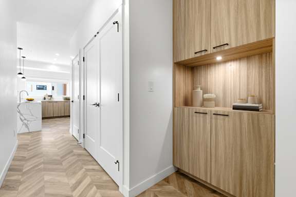 A hallway with a cabinet and a counter in it.