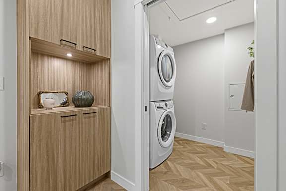 A modern laundry room with a washer and dryer.