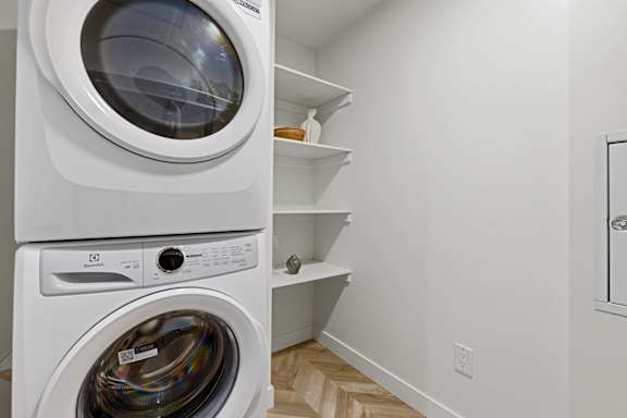A white washing machine and dryer in a small laundry room.