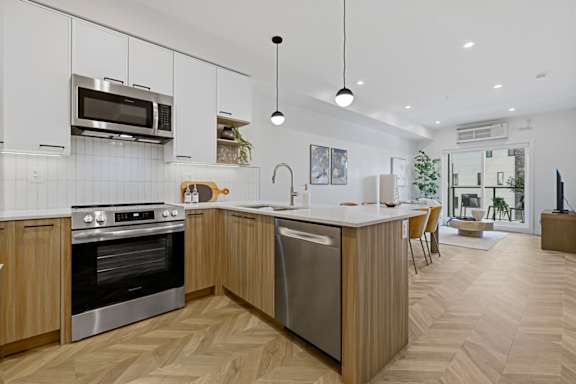 A modern kitchen with wooden cabinets and a large island.