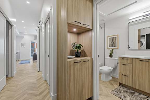 A bathroom with a toilet, sink, and mirror.