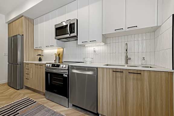 A modern kitchen with wooden cabinets and stainless steel appliances.