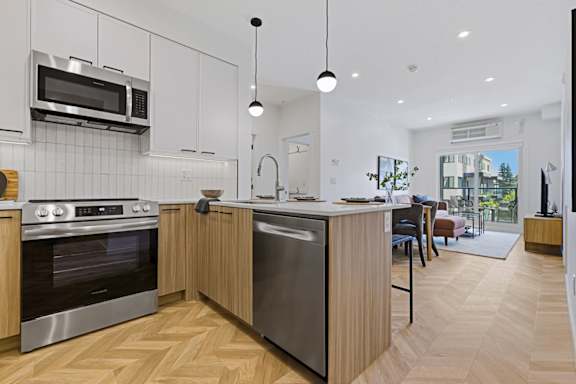 A modern kitchen with wooden cabinets and stainless steel appliances.