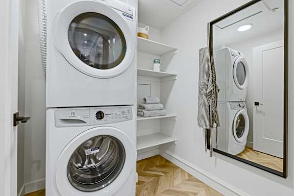 A white washing machine and dryer in a small laundry room.