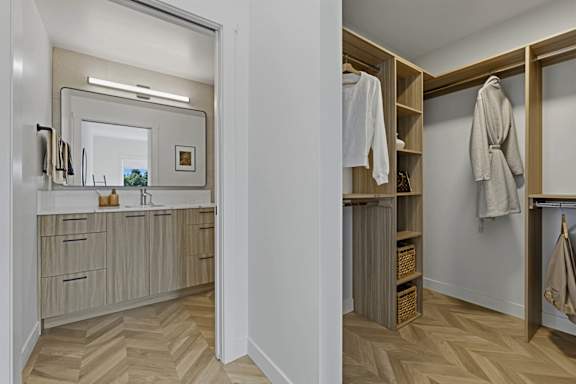 A bathroom with a mirror, sink, and wooden shelves.