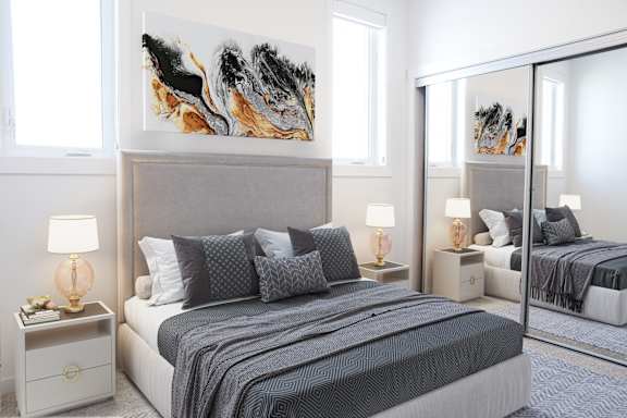 A bedroom with a large bed and a painting on the wall.