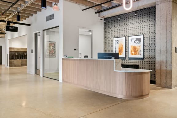 a lobby with a reception desk and a glass door