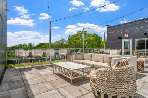 a patio with a couch and chairs and a coffee table