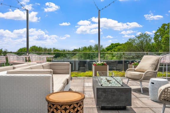 a patio with chairs and a table on a roof