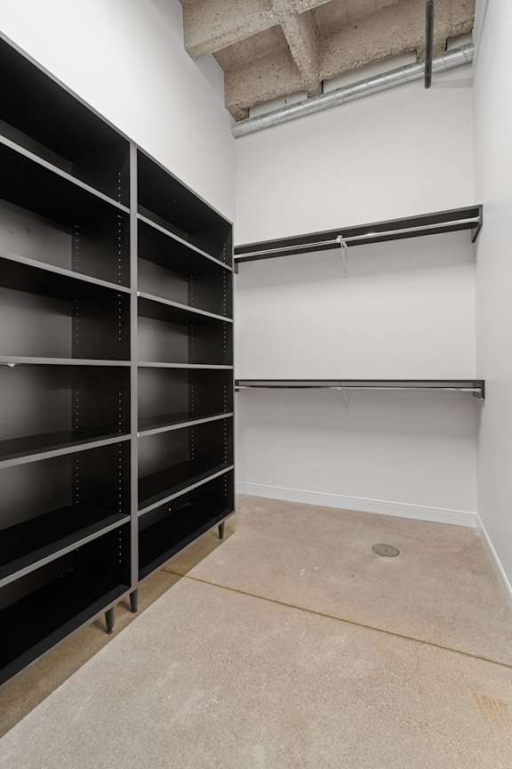 Empty storage room with black shelving units.