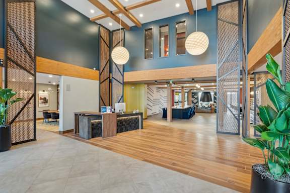 A reception area with a wooden floor and a reception desk.