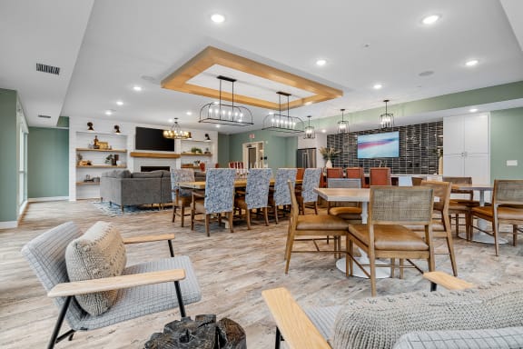 a living room with tables and chairs and a tv