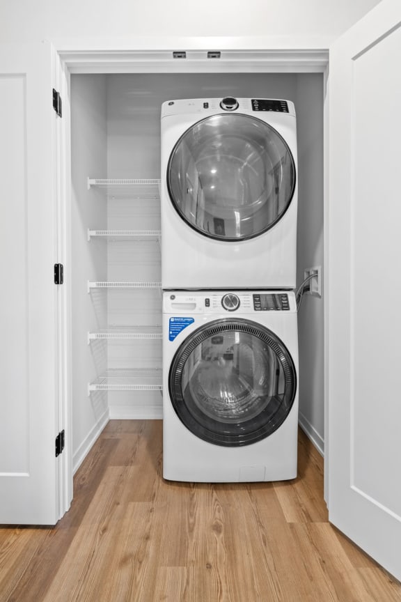a white washer and dryer in a small room