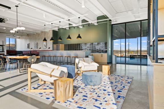 the living room and dining area of a modern office building with a view of a