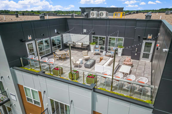 an aerial view of a rooftop patio with tables and chairs