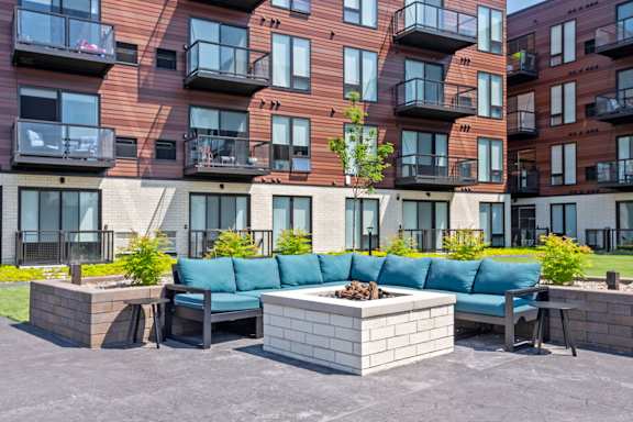A modern apartment complex with a courtyard and seating area.