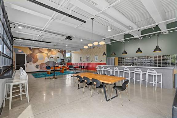 A modern meeting room with a long table and chairs.