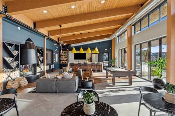 A modern living room with a grey sofa and a black coffee table.
