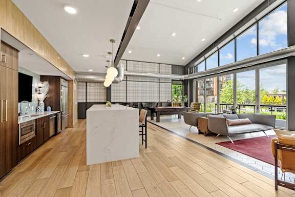 A modern kitchen with wooden floors and a large island in the middle.