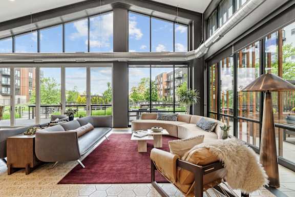 A large, modern living room with a view of the outdoors.