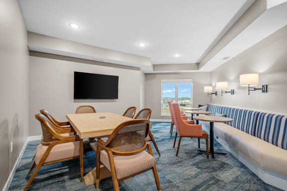 a living room with a table and chairs and a couch