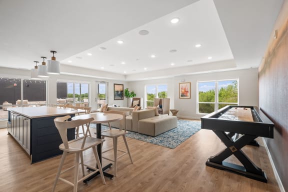 a living room with a kitchen and a table with chairs