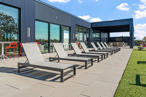 a row of lounge chairs outside of a building