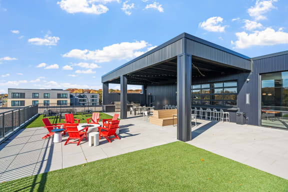 the outdoor patio of a building with red chairs and a patio