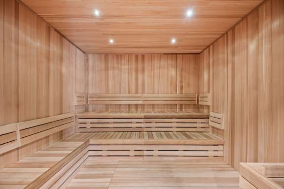 A wooden sauna with benches and a wooden floor.