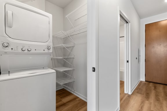 a laundry room with a washer and dryer and a closet