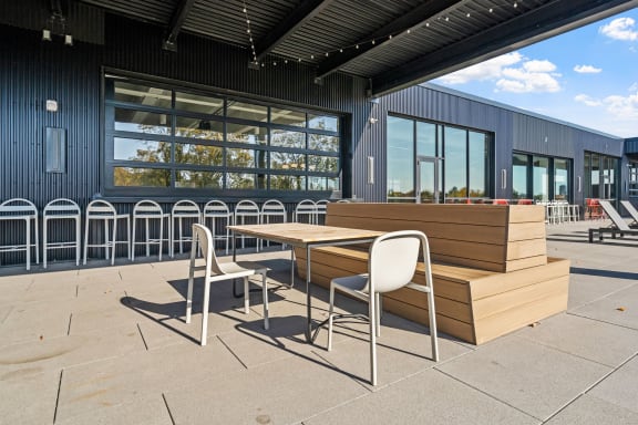 a patio with tables and chairs outside of a building